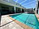 Gorgeous screened-in pool and spa features a spacious deck and lush landscaping at 1513 Maidstone Ct, Davenport, FL 33896