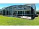 Private screened-in pool and spa boasts a tiled deck and scenic views of the expansive backyard at 1513 Maidstone Ct, Davenport, FL 33896