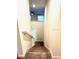 Staircase with carpeted steps and white railing leading to the upper level at 1513 Maidstone Ct, Davenport, FL 33896