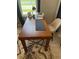 Close-up of a wooden desk with a modern chair and natural light from a nearby window at 15708 Orange Harvest Loop, Winter Garden, FL 34787