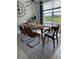 Modern dining room with large window, stylish chairs and minimalist decor at 15708 Orange Harvest Loop, Winter Garden, FL 34787