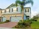 Charming townhome with a two-car garage and lush landscaping at 15708 Orange Harvest Loop, Winter Garden, FL 34787