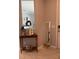 Welcoming foyer showcasing a decorative table with a mirror, creating an inviting entrance at 15708 Orange Harvest Loop, Winter Garden, FL 34787