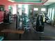 Well-equipped gym with weight machines, treadmills, and free weights at 15708 Orange Harvest Loop, Winter Garden, FL 34787