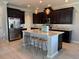 Elegant kitchen with stainless steel appliances and an island with bar seating at 15708 Orange Harvest Loop, Winter Garden, FL 34787