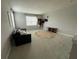 Open living room space with a cozy sofa, modern rug, and ample natural light at 15708 Orange Harvest Loop, Winter Garden, FL 34787