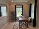 Well-lit home office featuring a wooden desk, neutral rug, and view of the outside scenery at 15708 Orange Harvest Loop, Winter Garden, FL 34787