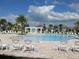 Community pool featuring comfortable lounge chairs for residents to relax and enjoy the sunny weather at 15708 Orange Harvest Loop, Winter Garden, FL 34787