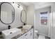 The bathroom features dual sinks, cabinets, and a shower at 166 Minniehaha Cir, Haines City, FL 33844