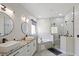 Bright bathroom featuring double sinks, a corner tub, and a frameless glass shower at 166 Minniehaha Cir, Haines City, FL 33844
