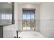 This bathroom features a tub with jets, a window, a sink, and vanity at 166 Minniehaha Cir, Haines City, FL 33844