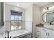 This bathroom features a tub with jets, large window, sink, and storage at 166 Minniehaha Cir, Haines City, FL 33844