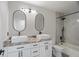 The bathroom features dual sinks, cabinets, and a shower and tub at 166 Minniehaha Cir, Haines City, FL 33844