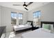 Charming bedroom with two twin beds, ceiling fan, and natural light from large windows at 166 Minniehaha Cir, Haines City, FL 33844
