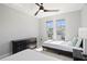 Bright bedroom featuring two twin beds, ceiling fan, and natural light from large windows at 166 Minniehaha Cir, Haines City, FL 33844