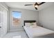 This bedroom features a ceiling fan, closet, and a window letting in natural light at 166 Minniehaha Cir, Haines City, FL 33844