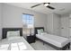 Comfortable bedroom featuring two beds, ceiling fan, and a large window view at 166 Minniehaha Cir, Haines City, FL 33844