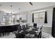 Contemporary dining area featuring modern lighting, and a glass-top table adjacent to the kitchen at 166 Minniehaha Cir, Haines City, FL 33844