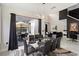 Well-lit dining area featuring an 8-seater glass top table, modern lighting, and patio views at 166 Minniehaha Cir, Haines City, FL 33844