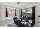 Dining area featuring an 8-seater glass top table, decorative lighting, and sliding doors to the patio at 166 Minniehaha Cir, Haines City, FL 33844