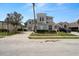 Well-manicured two-story home with lush landscaping and spacious driveway at 166 Minniehaha Cir, Haines City, FL 33844