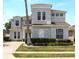 Stately two-story home featuring manicured landscaping and neutral toned exterior at 166 Minniehaha Cir, Haines City, FL 33844