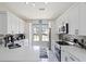 Bright, modern kitchen featuring white cabinets, stainless steel appliances, and quartz countertops at 166 Minniehaha Cir, Haines City, FL 33844