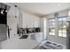 Modern kitchen with white cabinets, quartz counters, stainless appliances, and ample natural light at 166 Minniehaha Cir, Haines City, FL 33844