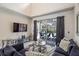 The living room features a sofa, pillows, tv, and an outdoor view of the patio at 166 Minniehaha Cir, Haines City, FL 33844