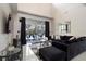 Modern living room with large windows, stylish furniture, and dark accents at 166 Minniehaha Cir, Haines City, FL 33844