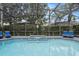 An in-ground pool with spa inside a screened enclosure at 166 Minniehaha Cir, Haines City, FL 33844