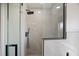 A modern shower with glass door, silver tile, and a shower head at 166 Minniehaha Cir, Haines City, FL 33844