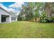 Expansive backyard featuring lush greenery and a designated fire pit area for outdoor gatherings at 1800 Silver Valley Ct, Apopka, FL 32712