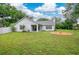Spacious backyard with green grass, a fire pit, and a white fence, perfect for outdoor activities at 1800 Silver Valley Ct, Apopka, FL 32712