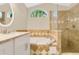 Modern bathroom featuring tiled tub, walk-in shower, vanity with stone counters, and bright natural light at 1800 Silver Valley Ct, Apopka, FL 32712