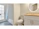 Bright bathroom featuring shower/tub combo, granite counters, vanity and a door to the exterior at 1800 Silver Valley Ct, Apopka, FL 32712