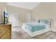 Serene bedroom showcasing a plush bed with a blue comforter and ample natural light at 1800 Silver Valley Ct, Apopka, FL 32712