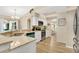 Bright kitchen featuring white cabinets, stainless appliances, granite countertops, and wood floor at 1800 Silver Valley Ct, Apopka, FL 32712