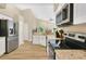 Well-lit kitchen featuring granite countertops, stainless steel appliances, and wood-look flooring at 1800 Silver Valley Ct, Apopka, FL 32712