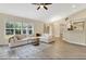 Inviting living room with large windows, a comfortable sectional sofa, and hardwood floors at 1800 Silver Valley Ct, Apopka, FL 32712