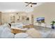Open living room with high ceilings, neutral colors, and seamless flow into the dining area at 1800 Silver Valley Ct, Apopka, FL 32712
