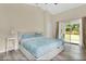 Calm main bedroom with a vaulted ceiling and slider doors leading to a serene outdoor space at 1800 Silver Valley Ct, Apopka, FL 32712