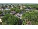 Aerial view showcases a residential neighborhood with mature trees, paved roads, and varied housing styles at 1803 Foxhall Cir # 1803, Kissimmee, FL 34741