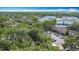 An aerial view showcases the neighborhood's mature trees, modern buildings, and ample parking spaces at 1803 Foxhall Cir # 1803, Kissimmee, FL 34741