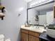 Bathroom featuring a wooden vanity with granite countertop, white vessel sink, and modern fixtures at 1803 Foxhall Cir # 1803, Kissimmee, FL 34741