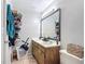 Bathroom with a double sink vanity, large mirror, and wall shelving for ample storage at 1803 Foxhall Cir # 1803, Kissimmee, FL 34741