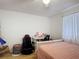 Bedroom featuring light walls and wood floors. Includes a desk, gaming chair and hamper at 1803 Foxhall Cir # 1803, Kissimmee, FL 34741