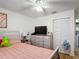 Bedroom featuring light walls, wood floors, a window, and closet with bifold doors at 1803 Foxhall Cir # 1803, Kissimmee, FL 34741
