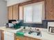 Kitchen featuring stainless steel sink, dishwasher, and warm wood cabinets at 1803 Foxhall Cir # 1803, Kissimmee, FL 34741