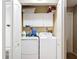 Laundry room showcasing a full-size washer and dryer, white cabinets, and overhead storage space at 1803 Foxhall Cir # 1803, Kissimmee, FL 34741